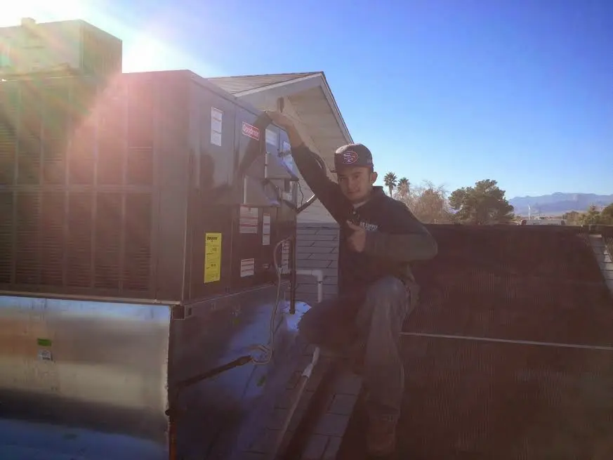 HVAC technician performing HVAC Inspection on a rooftop unit in Salem
